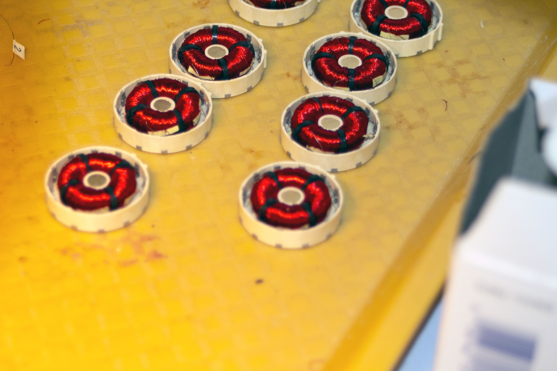 PWI precision tape-wound toroidal coils in production trays