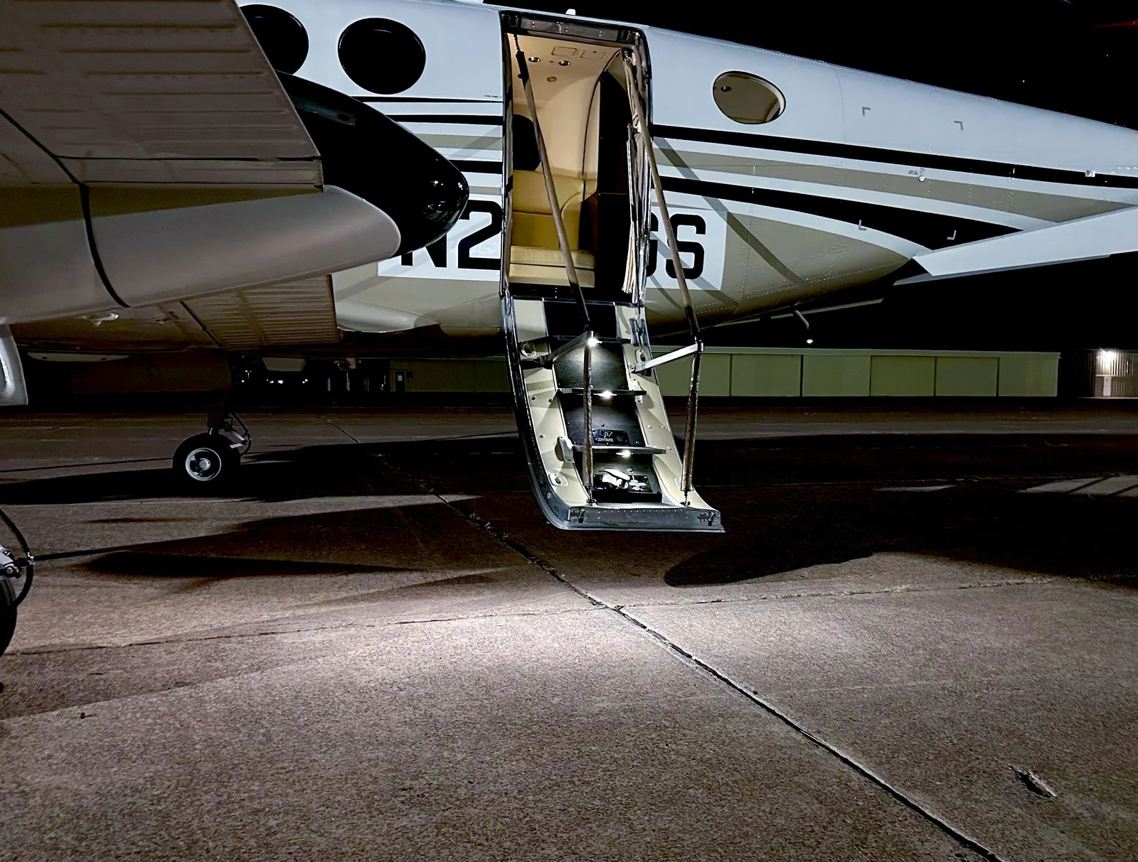 PWI LED entry door light illuminating aircraft airstair steps at night