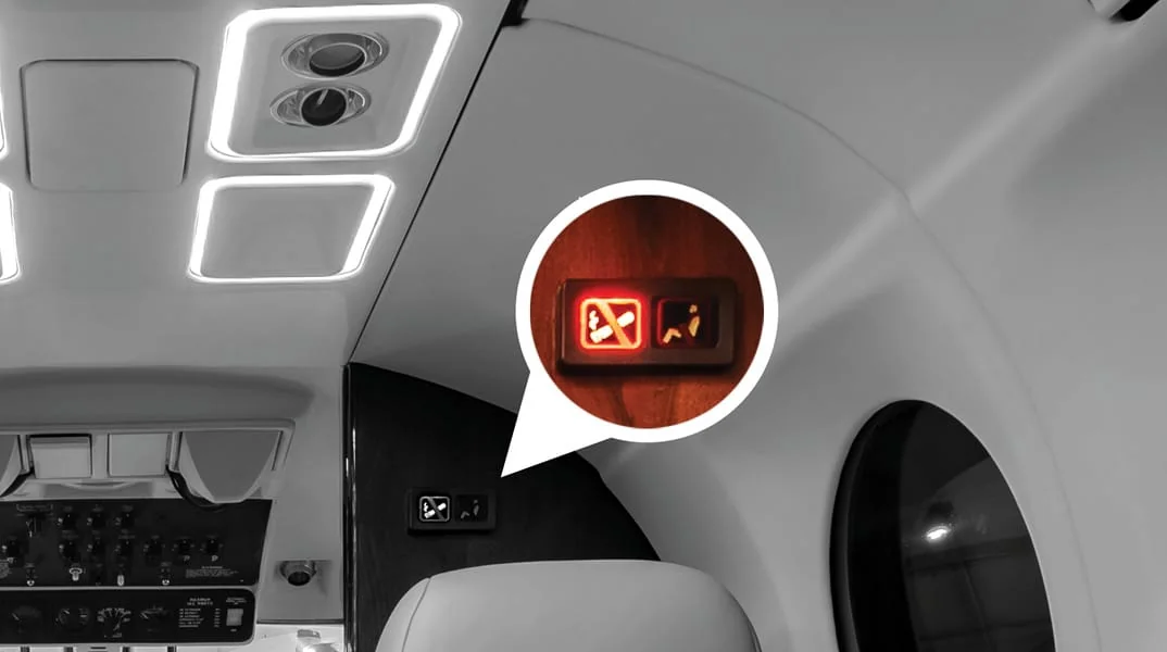PWI seat belt / smoking sign illuminated and installed in aircraft cabin